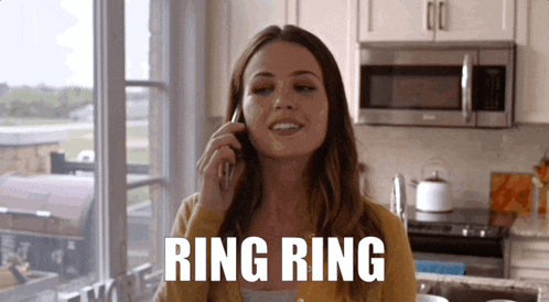 a woman in a kitchen talking on a cell phone with the word ring ring below her
