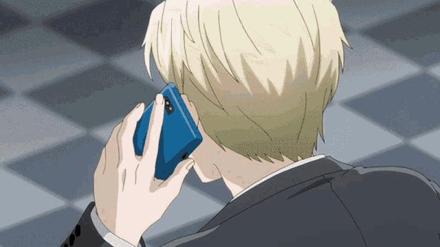 a man in a suit talks on a cell phone