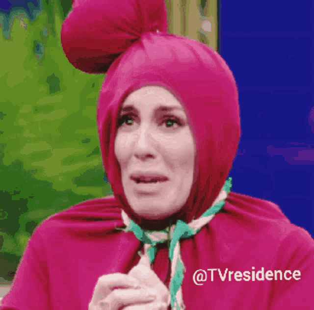 a woman in a pink costume with a scarf around her neck and the words @tvresidence on the bottom