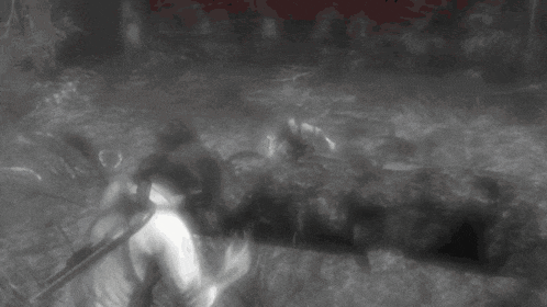 a black and white photo of a person walking through a forest