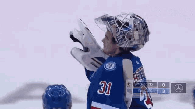 a hockey game is being played between penguins and rangers