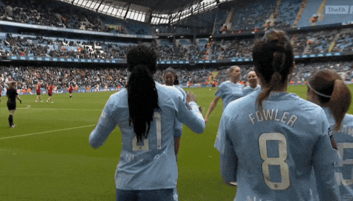 a group of female soccer players including fowler and number 8