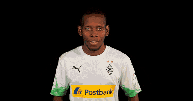 a man wearing sunglasses and a shirt that says postbank on it