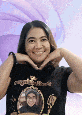 a woman wearing a black t-shirt with a picture of a woman in a mirror on it