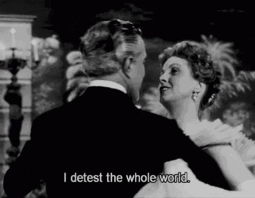 a black and white photo of a man and woman dancing with the caption i detest the whole world .