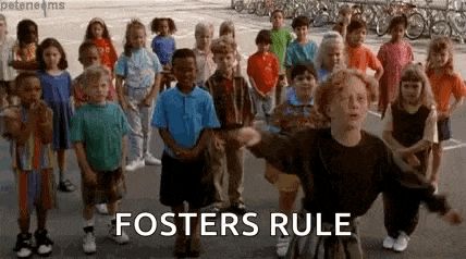 a group of children are standing next to each other and a man is standing in front of a group of children .