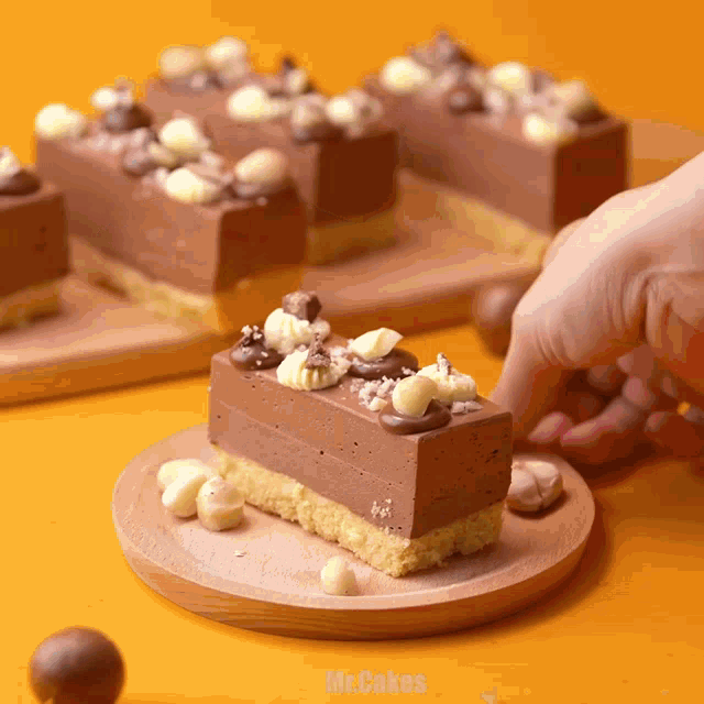 a piece of chocolate cake on a wooden plate with mr.cakes written in the corner