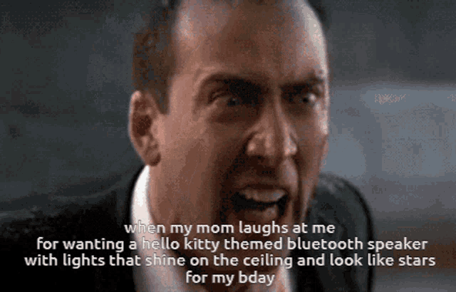 a man in a suit and tie is screaming with a caption that says when my mom laughs at me