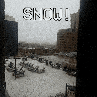 a view of a snowy city from a balcony with the words `` snow ! '' written on it .