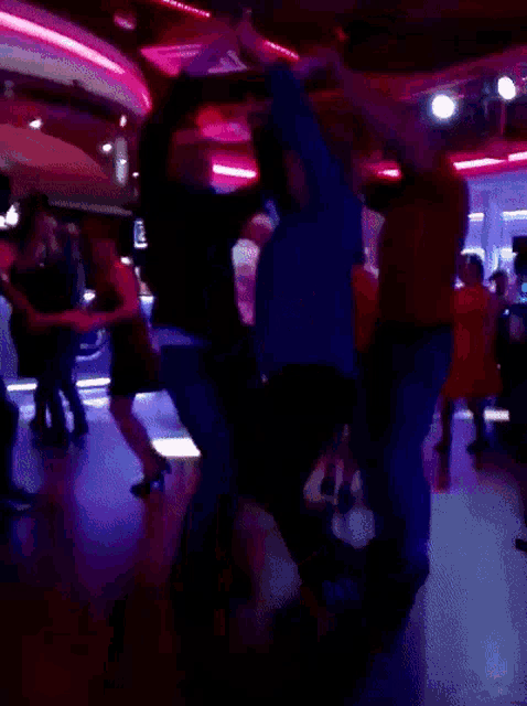 a group of people dancing in a dark room