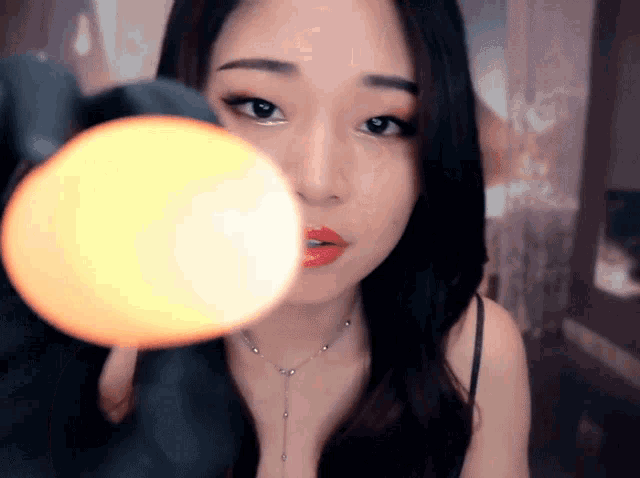 a close up of a woman 's face with a light shining on it