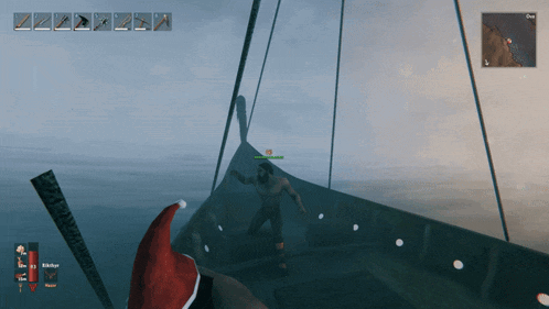 a man wearing a santa hat is standing on a boat