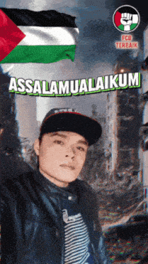 a man wearing a hat stands in front of a flag with the words assalamualaikum on it