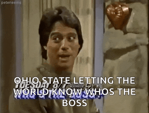 a man is holding a heart in his hand and says `` ohio state letting the world know who is the boss '' .