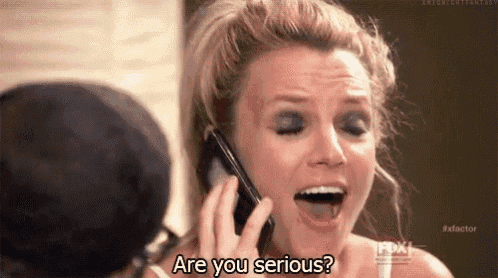 britney spears is talking on a cell phone and asking if she is serious .