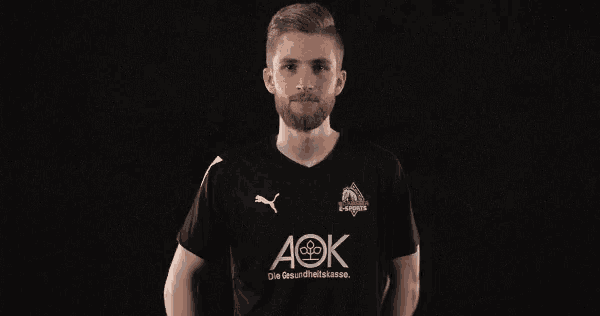 a man wearing a black shirt with aok written on it