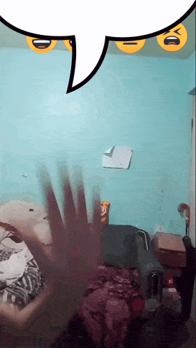 a person 's hand is waving in front of a speech bubble