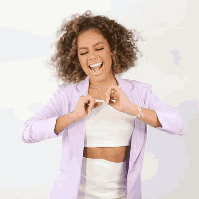 a woman making a heart shape with her hands