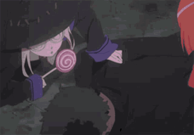 a girl in a black hat is holding a lollipop .