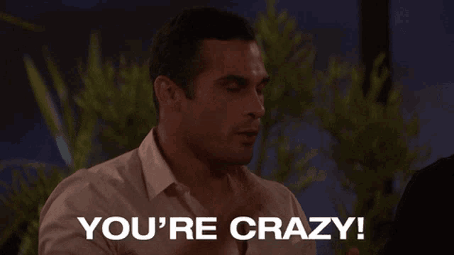 a man says " you 're crazy " in front of a blurred background
