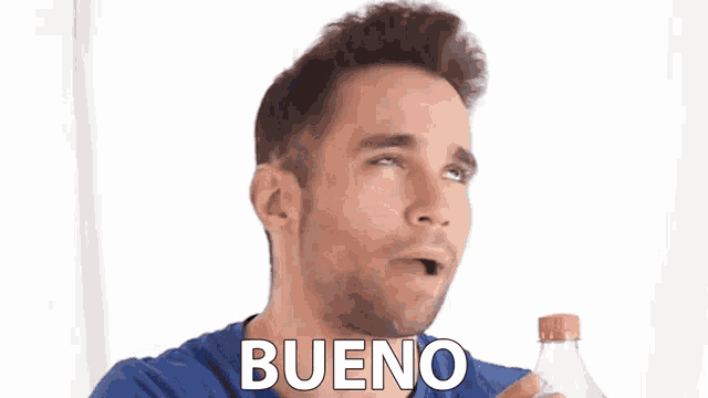 a man in a blue shirt is holding a bottle with the word bueno written on it