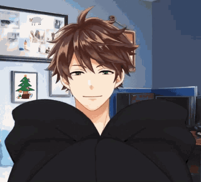 a man in a black hoodie is standing in front of a christmas tree