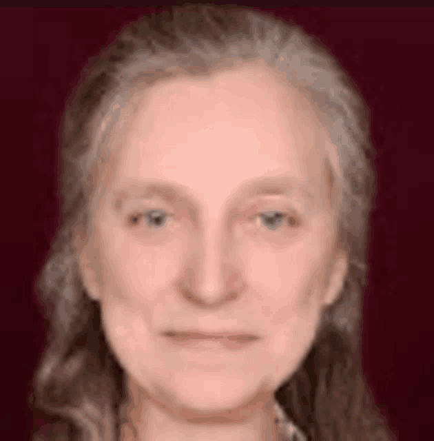 a close up of a woman 's face with a red background .