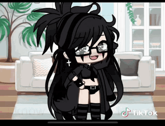 a girl with black hair and glasses is in a living room .