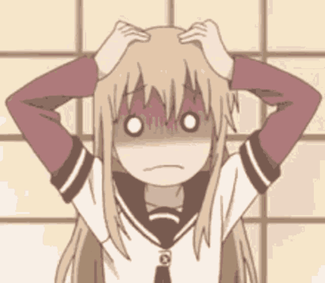 a girl in a school uniform is holding her head with her hands .
