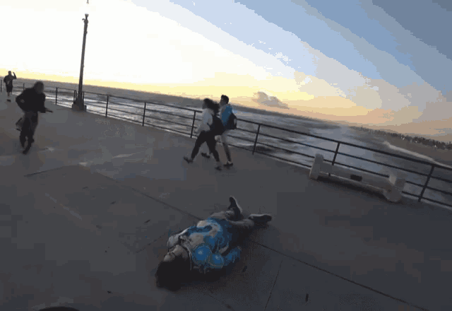 a person is laying on the ground on a pier