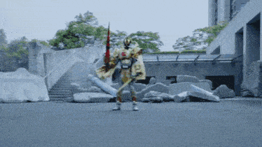 a robot with a sword and a cape is standing in a concrete area