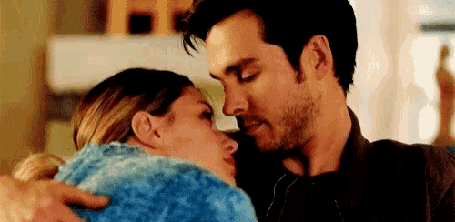 a man and a woman are hugging and kissing each other .