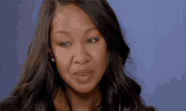 a close up of a woman 's face with a serious look on her face .