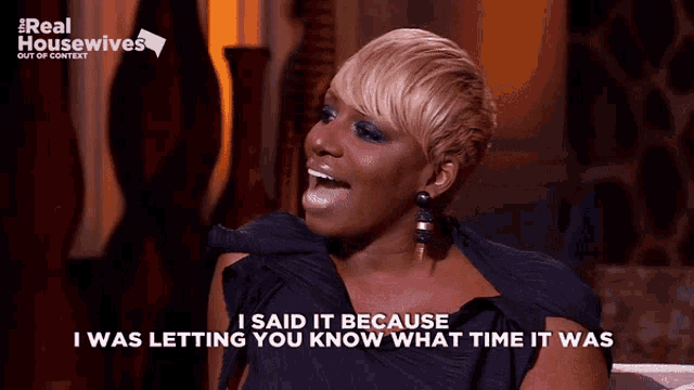 a woman sitting on a couch with the words " i said it because i was letting you know what time it was "