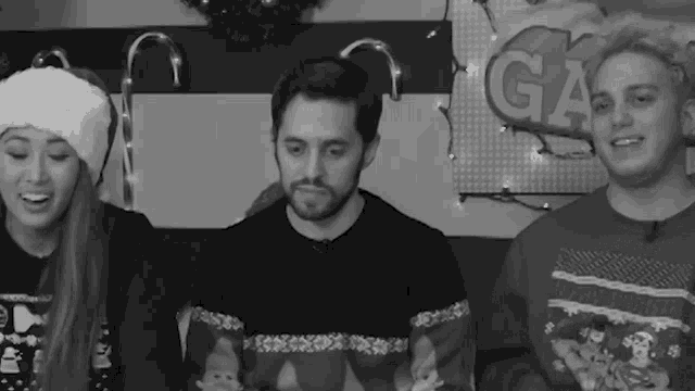 a group of people are sitting in front of a sign that says ga on it