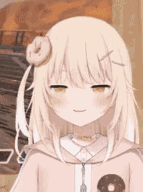 a girl with a donut on her head is smiling