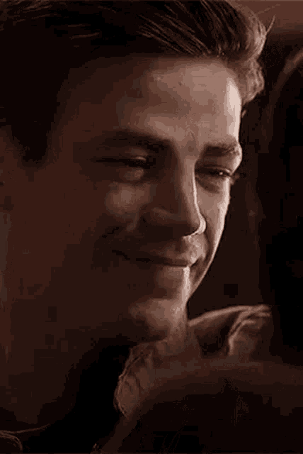 a close up of a man 's face with a woman 's face behind him .
