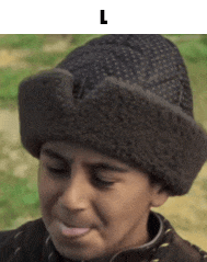 a boy wearing a fur hat with the letter l on the bottom