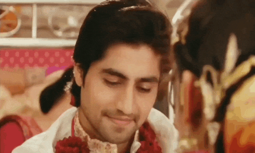 a man and a woman are looking at each other and smiling .