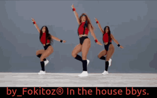 a woman in a red top and black swimsuit is dancing