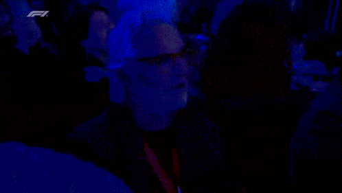 a blurry picture of a man in a crowd with a f1 logo