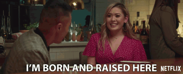 a man and a woman are sitting at a table with the words " i 'm born and raised here netflix " above them