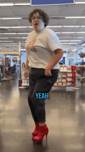 a woman wearing red high heels is dancing in a store with yeah written in blue