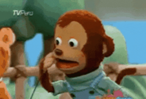 a stuffed monkey with a blue shirt and overalls is on a tv show