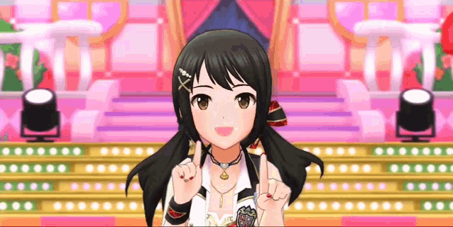 a girl is standing on a stage in front of a pink curtain and giving a peace sign .