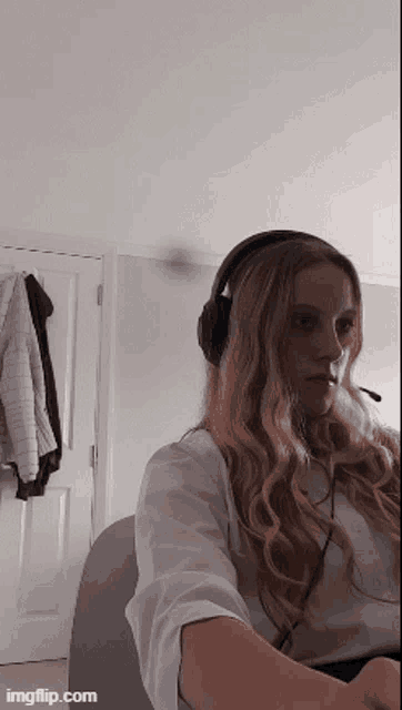 a woman is wearing headphones and a microphone