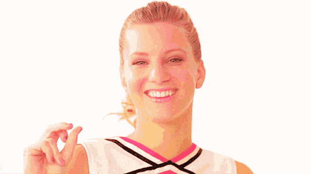 a cheerleader is smiling and giving a thumbs up