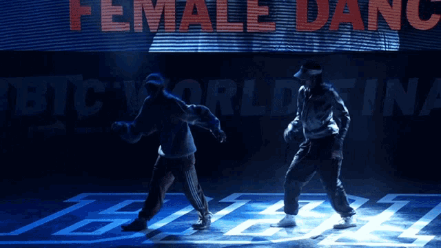 two people are dancing in front of a screen that says female dance
