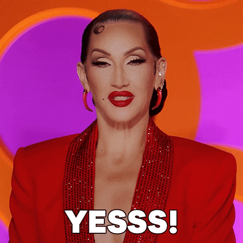 a woman in a red jacket says yesss in white