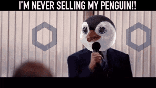 a man with a penguin mask on speaking into a microphone with the caption i 'm never selling my penguin